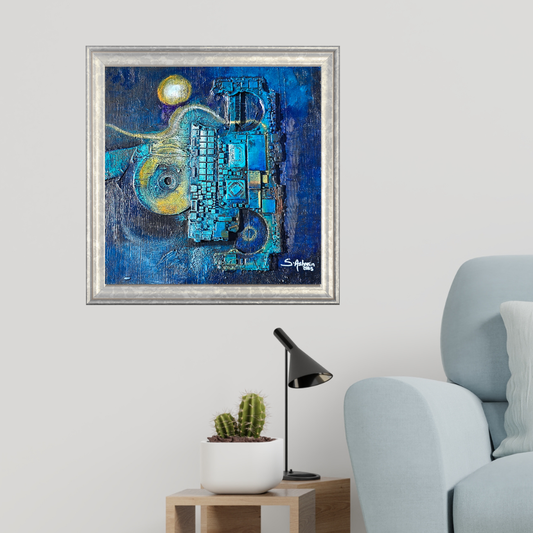 Abstract blue painting in a silver frame on a wall above a light blue armchair.