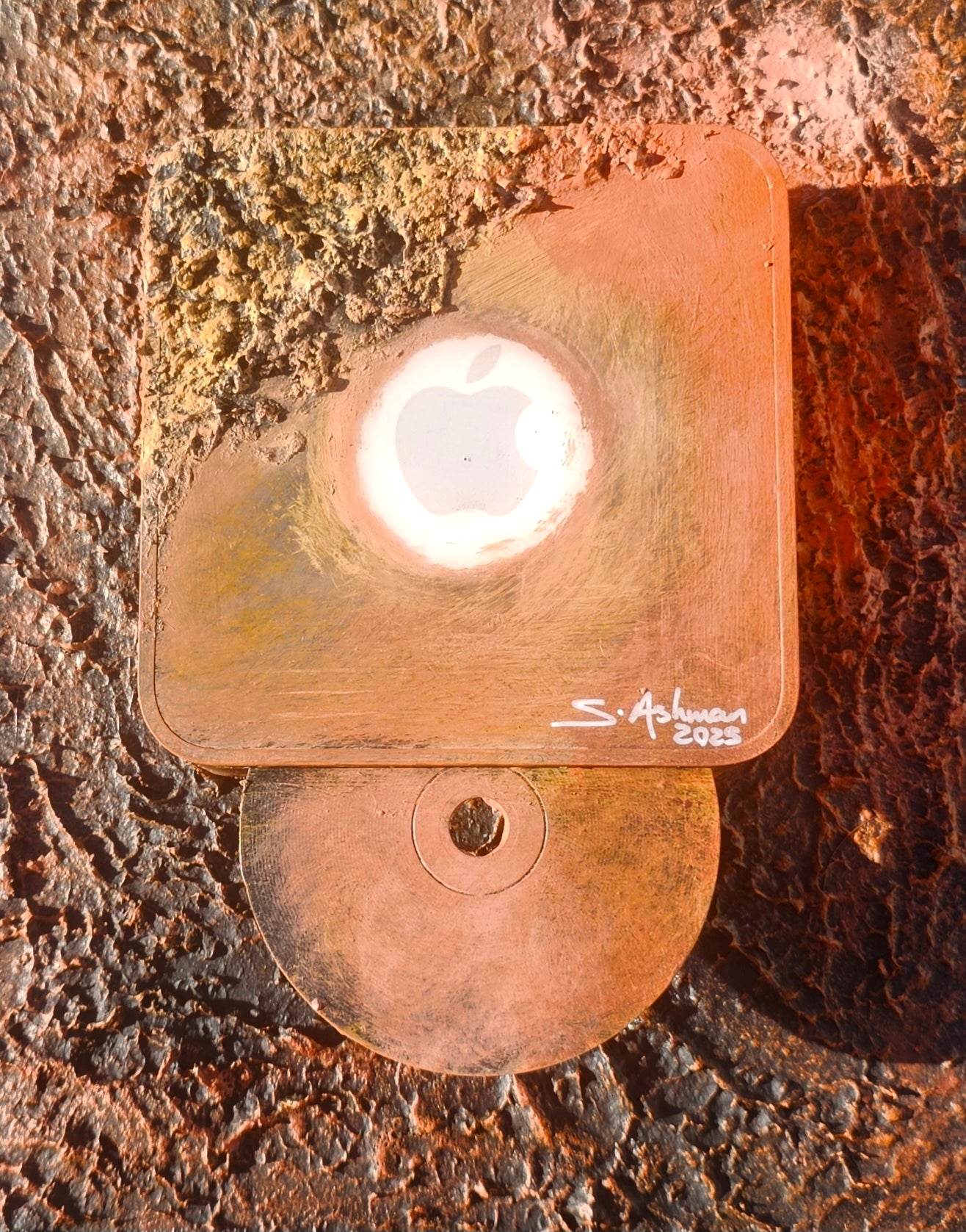 Copper night light with a white bulb on a textured brown surface